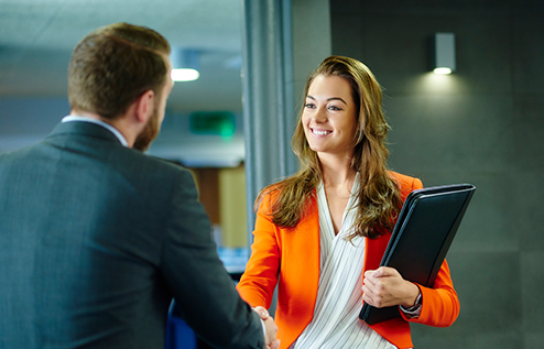 Women executive inviting a business man